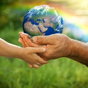 A father and child holding the Earth in their hands.