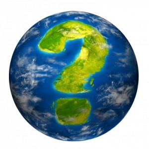 Earth question symbol represented by a world globe model with a geographic shape of a mark questioning the state of the environment the international economy and political situation.