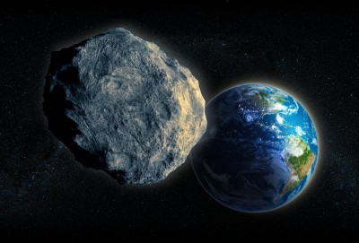 A picture of an asteroid and the Earth in space.