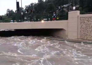 Rising water under a bridge in Evergreen, Colorado.
