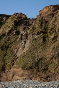 Many times, humans develop too close to cliff sides, and their homes and buildings are damaged when the cliff breaks apart.